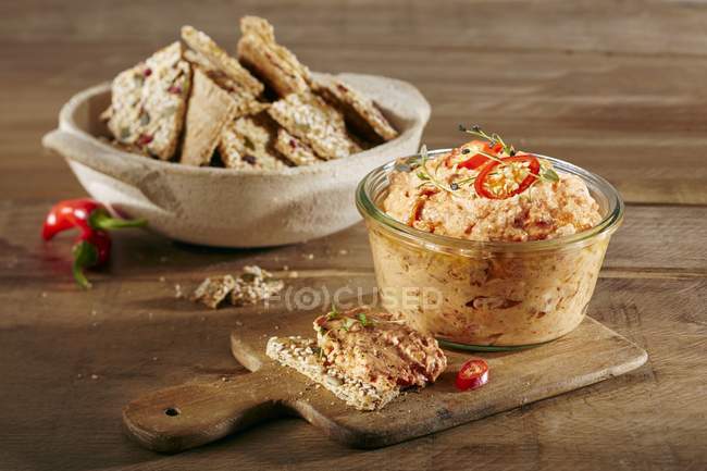 Spicy pepper dip with Thai chillis over wooden surface — Stock Photo