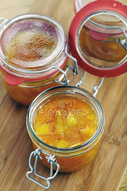 Closeup view of citrus fruit marmalade in preserving jars — Stock Photo