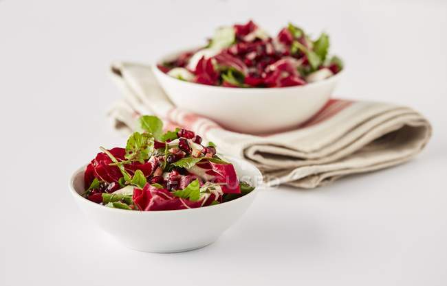 Salads with rocket and pomegranate in bowls — Stock Photo