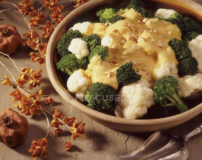 Cauliflower and broccoli with sauce — Stock Photo