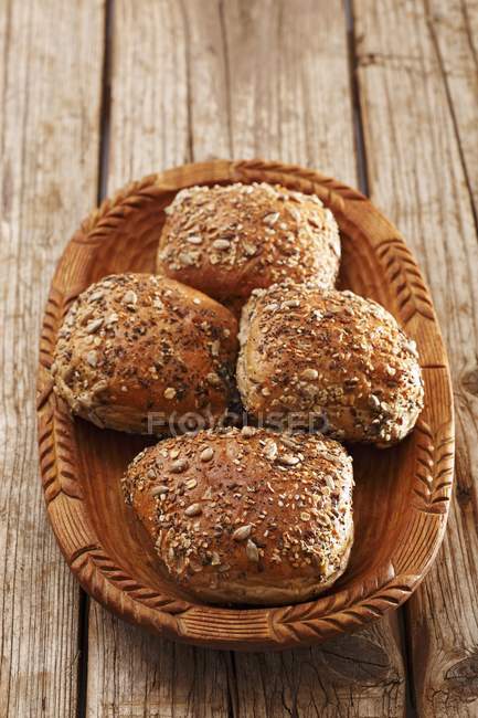 Seeded rolls in wooden bowl — Stock Photo