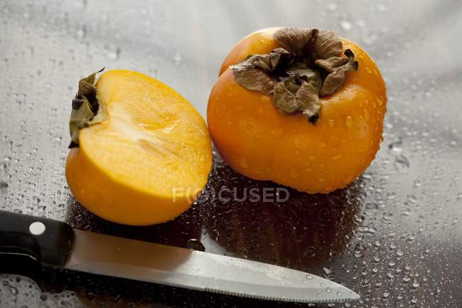 Fresh Persimmons with half — Stock Photo