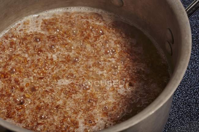 Bulgur cooking in pot — Stock Photo