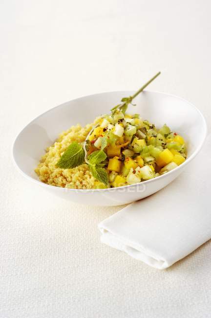Fruit salad with couscous and peppermint — Stock Photo