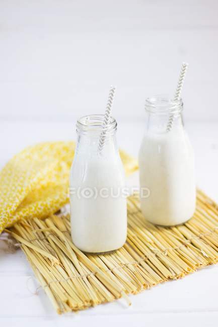 Banana smoothies in bottles — Stock Photo