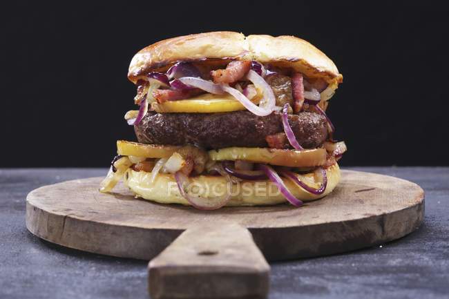 Burger on wooden board — Stock Photo