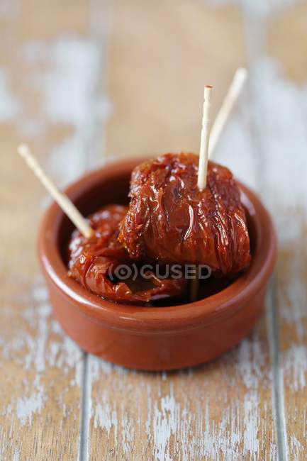 Dried tomatoes with toothpicks — Stock Photo