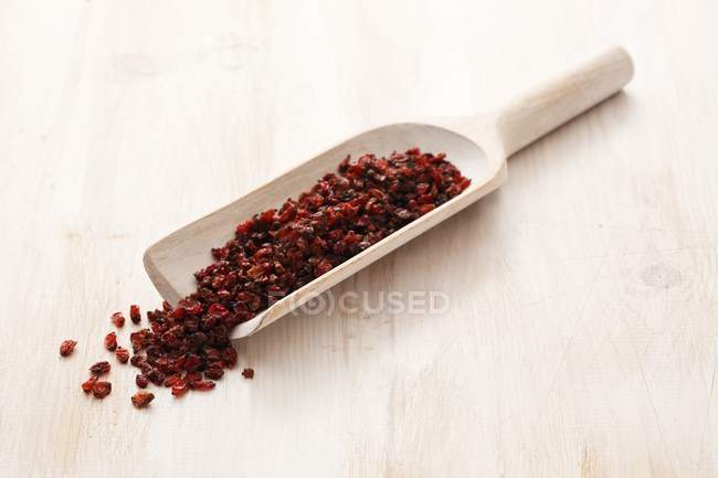 Dried barberries on wooden scoop — Stock Photo