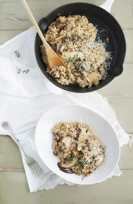 Top view of Risotto with mushrooms in pan and bowl — Stock Photo