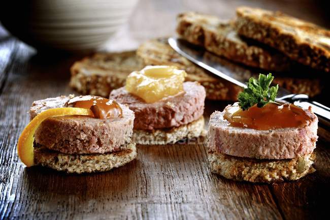 Closeup view of toasts topped with duck pate and jam — Stock Photo