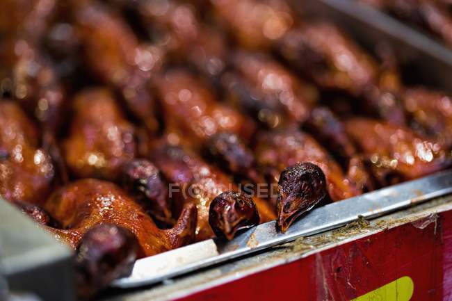 Closeup view of whole grilled birds in metal dish — Stock Photo