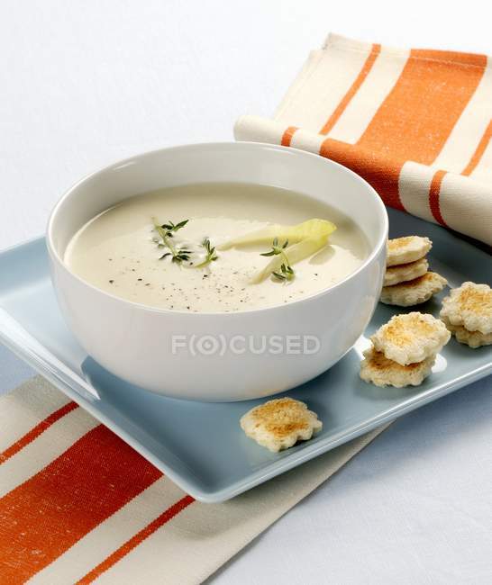 Cream of chicory soup in bowl — Stock Photo