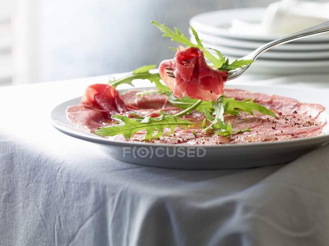 Beef carpaccio with pepper — Stock Photo