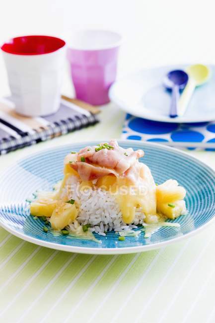 Rice with pineapple, cheese sauce and ham — Stock Photo