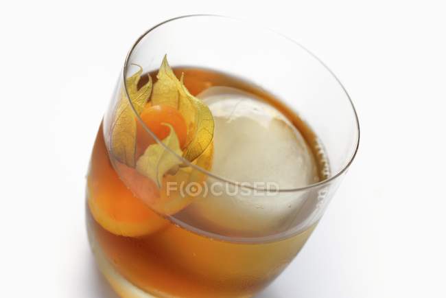 Shot drink with an ice cube — Stock Photo