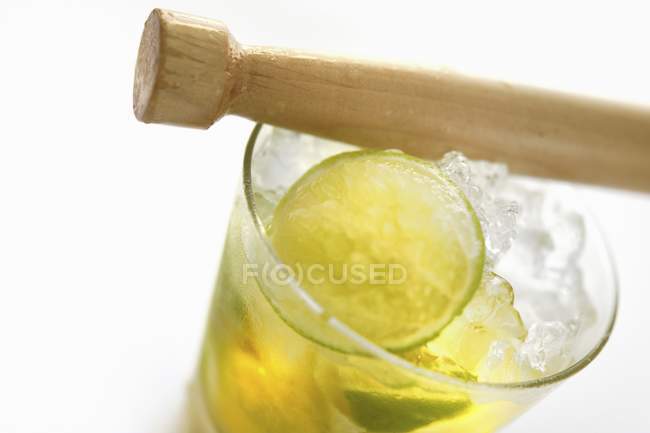 Mojito with a wooden muddler — Stock Photo