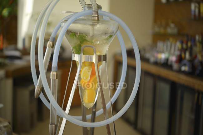 An Arabian water pipe with fruit indoors — Stock Photo