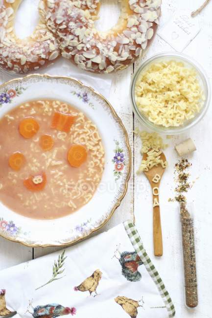 Sieved tomato soup with alphabet pasta — Stock Photo