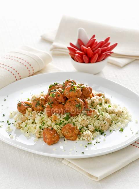 Couscous with meatballs in tomato sauce — Stock Photo