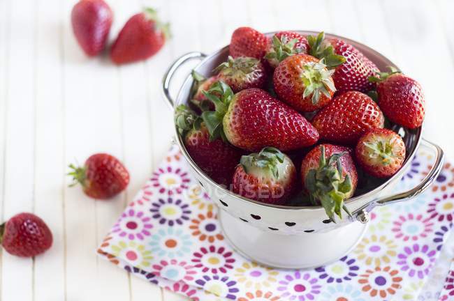Strawberries in enamel colander — Stock Photo