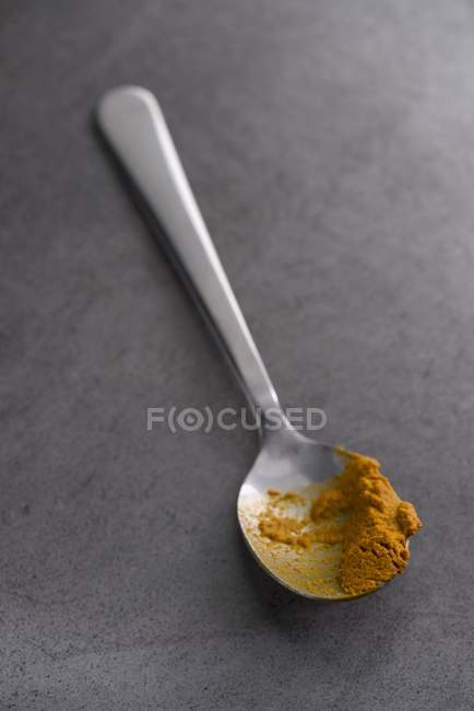 Turmeric paste on metal spoon — Stock Photo