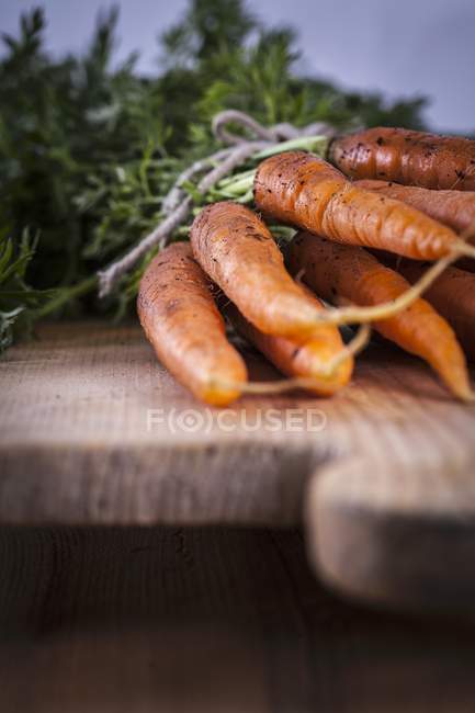 Fresh carrots on board — Stock Photo