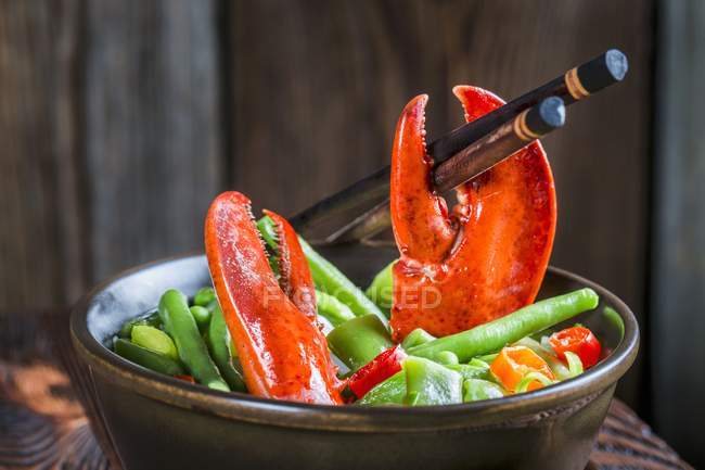 Noodles with vegetables and lobster — Stock Photo