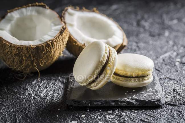 Coconut macarons on black stone — Stock Photo