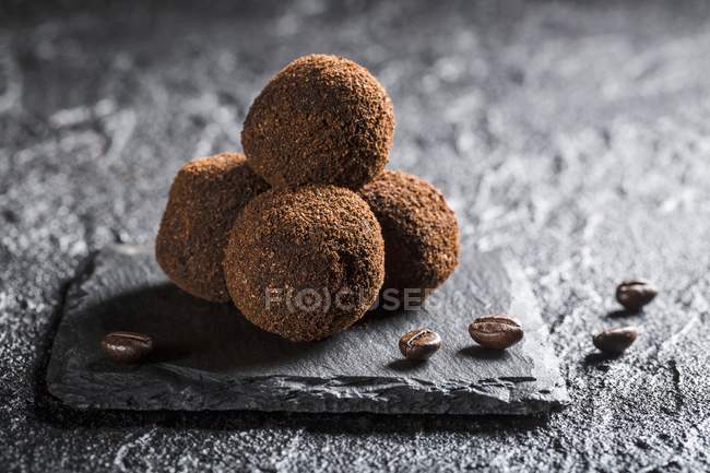 Truffle pralines with coffee — Stock Photo
