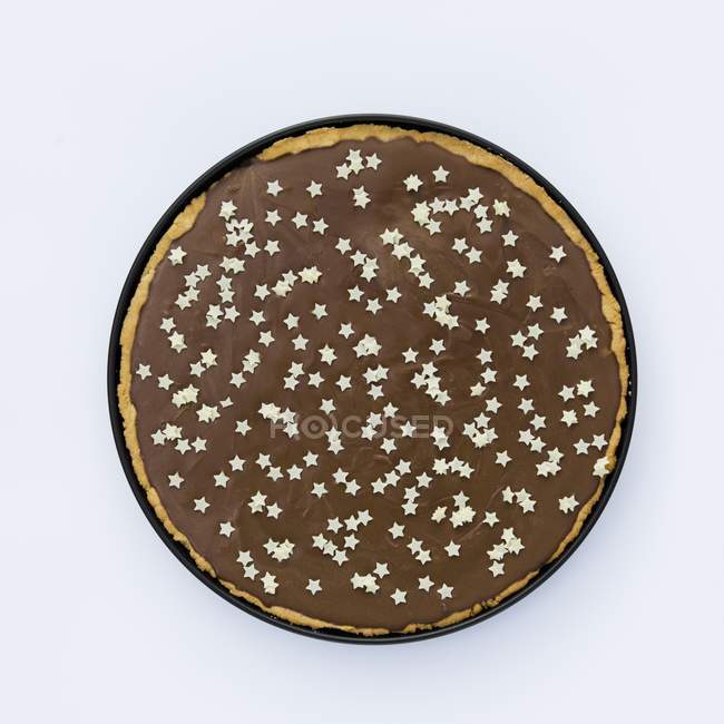 Closeup top view of Tarte au chocolat decorated with small white stars — Stock Photo