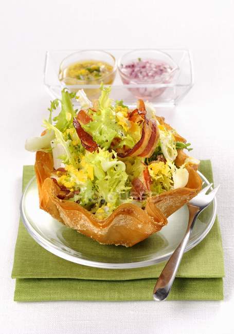 Lettuce salad with bacon and two sauces — Stock Photo