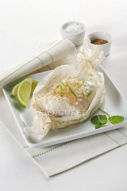 Baked Cod in parchment paper — Stock Photo