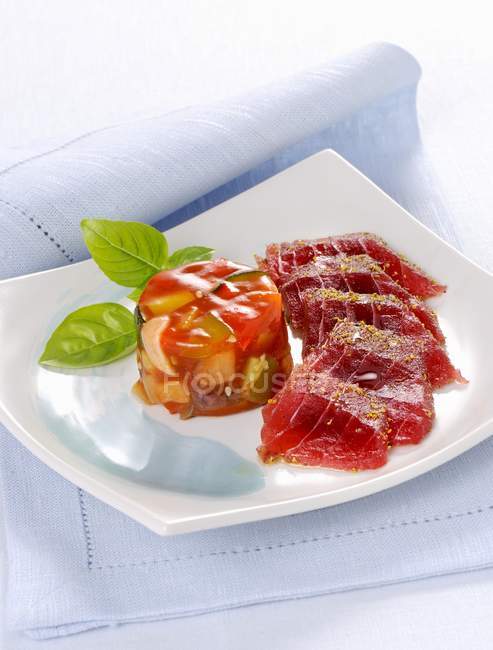 Closeup view of raw tuna fish with a Ratatouille jelly — Stock Photo