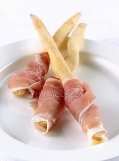 Breadsticks with San Daniele ham — Stock Photo