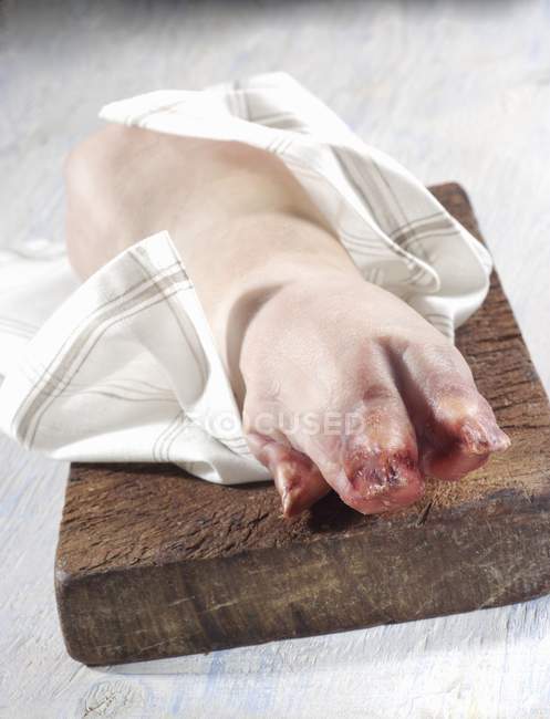 Pig's trotter on board — Stock Photo