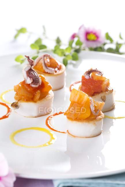 Scallops with salmon and baby octopus — Stock Photo