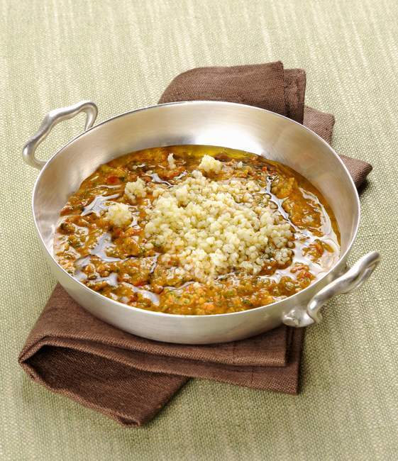 Bulgur in a vegetable and anchovy sauce — Stock Photo