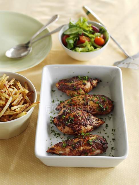 Barbecued chicken with chips and salad — Stock Photo
