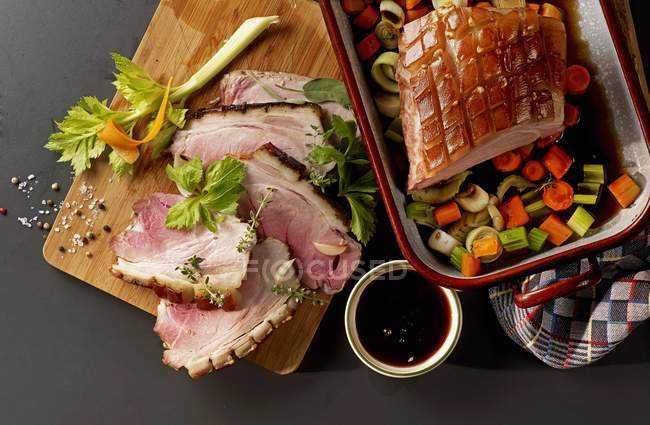 Close up of  Crispy roast pork with balsamic sauce and colourful vegetables (seen from above) — Stock Photo