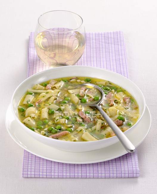 Noodle soup with peas and strips of ham — Stock Photo