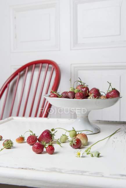 Strawberries on white cake stand — Stock Photo