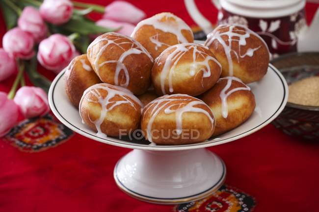 Mini doughnuts with white icing — Stock Photo