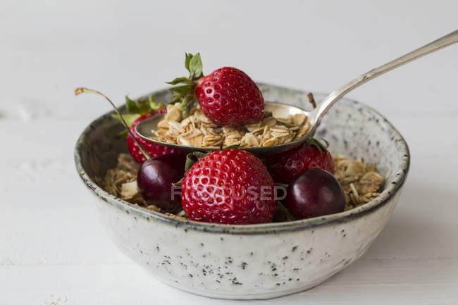 Bowl of muesli with strawberries and cherries — Stock Photo