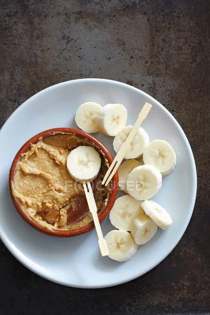 Banana with peanut butter — Stock Photo