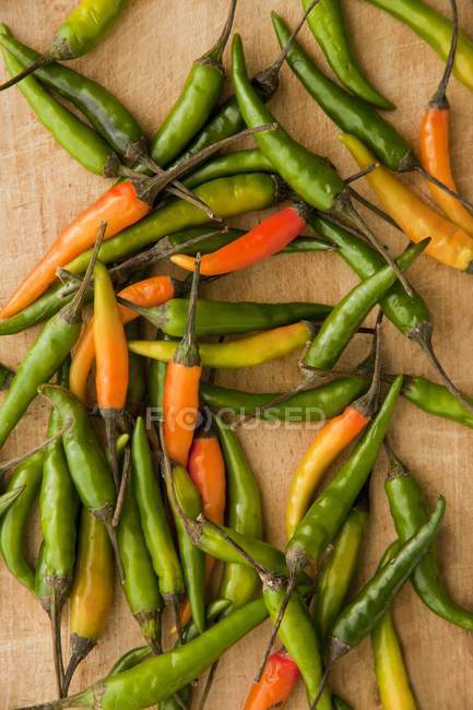 Thai chillis on a wooden chopping board — Stock Photo