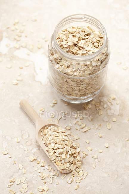 Oats in a jar and scoop — Stock Photo