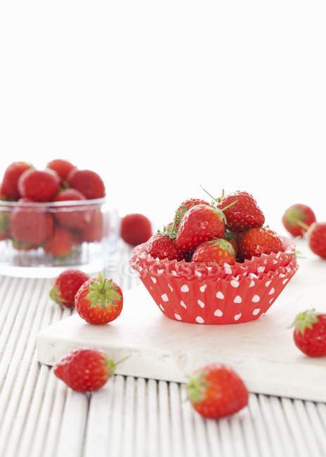 Fresh strawberries over desk — Stock Photo
