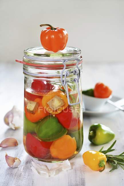 Colourful pickled peppers filled with tofu in  jar — Stock Photo