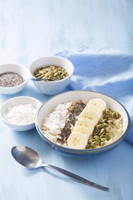 Porridge with bananas and coconut flakes — Stock Photo