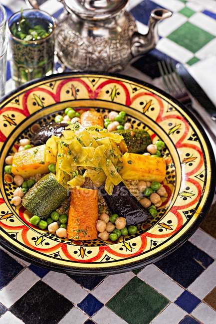Closeup view of couscous with vegetables and tea — Stock Photo